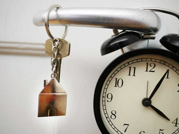 house keys next to clock counting down