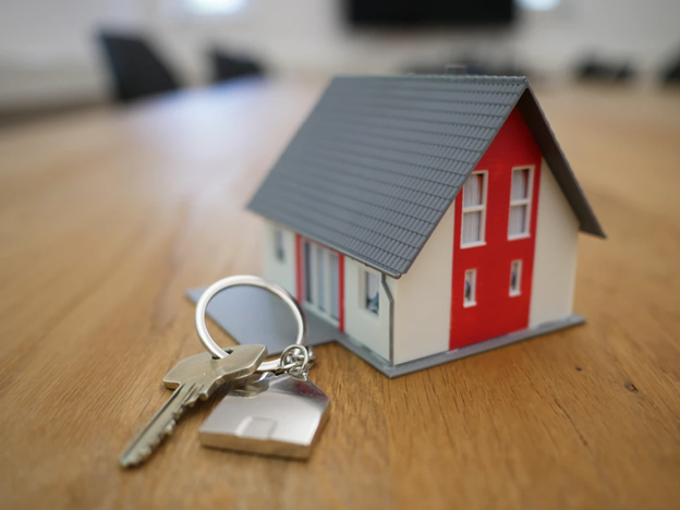 house keys next to model of a home