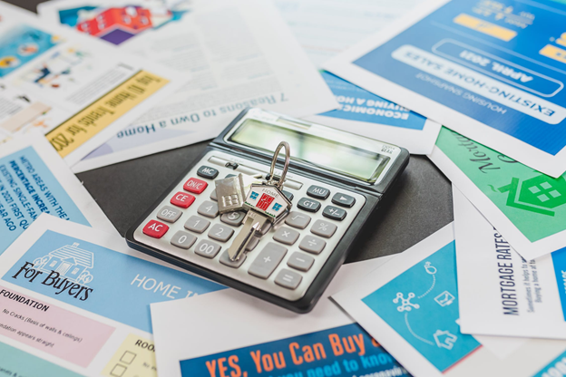 calculator on a desk with house keys