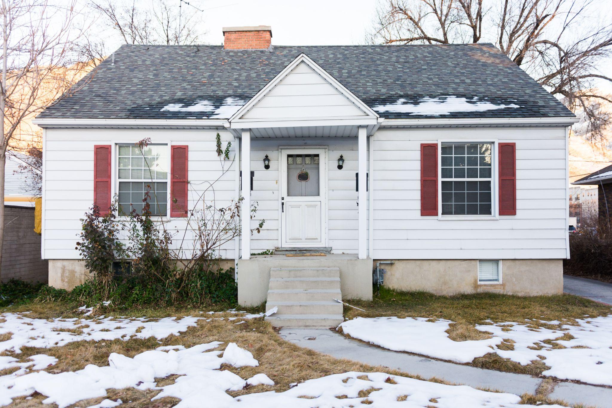 single story home in small town after snow fall