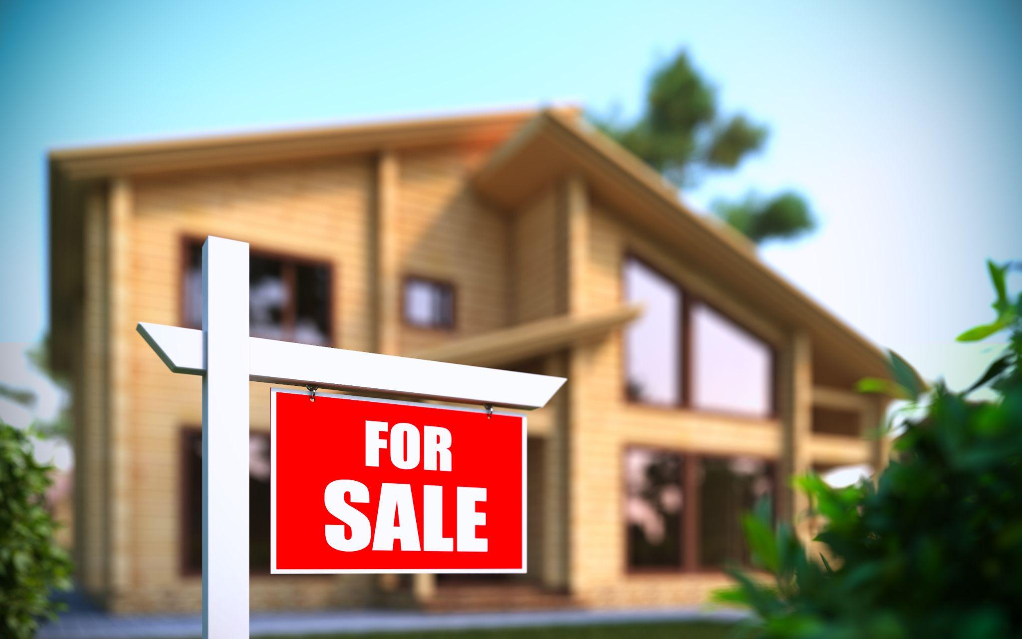 "Home For Sale" sign in front of new house