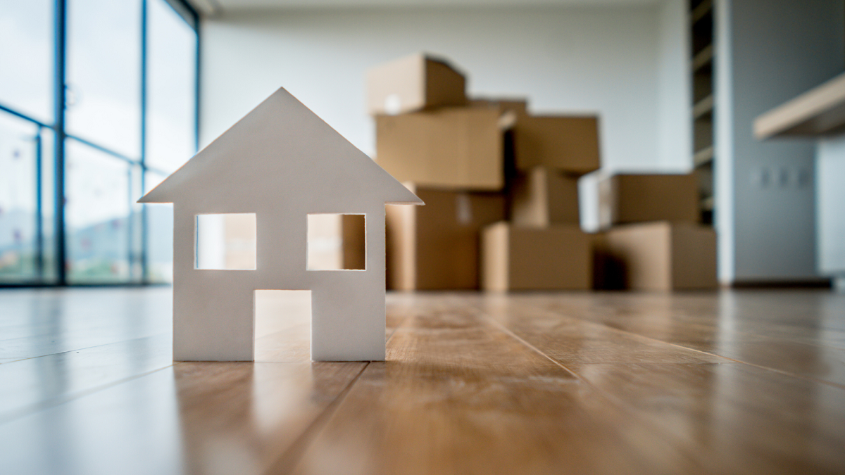 Model of the house on the floor in the new bright house.