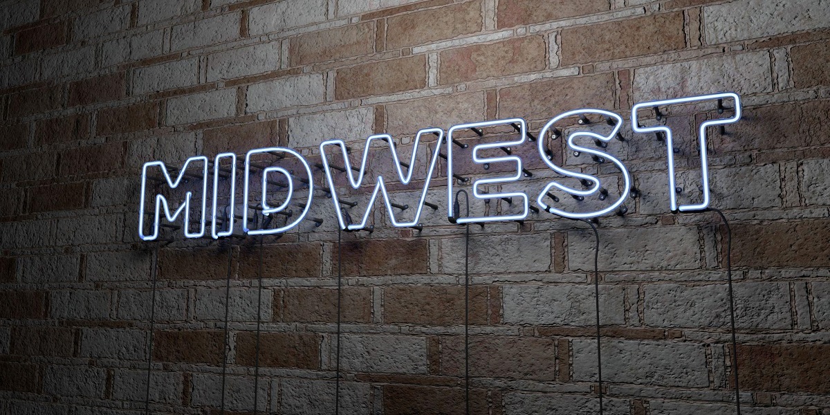 Midwest - glowing neon sign on stonework wall