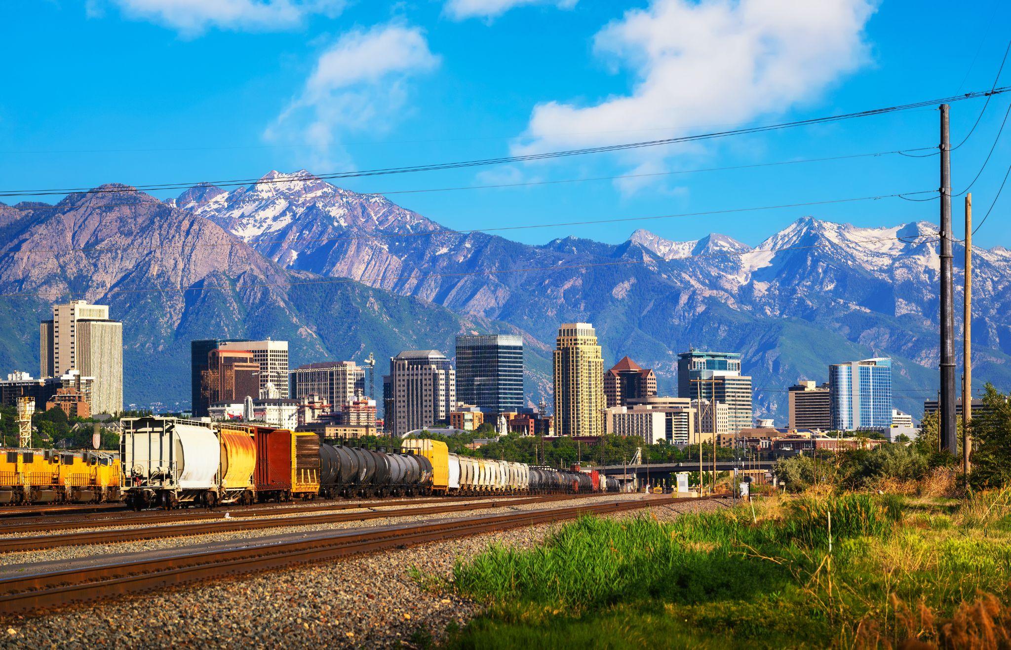 Salt Lake City, UT skyline and train tracks with mountains in the background