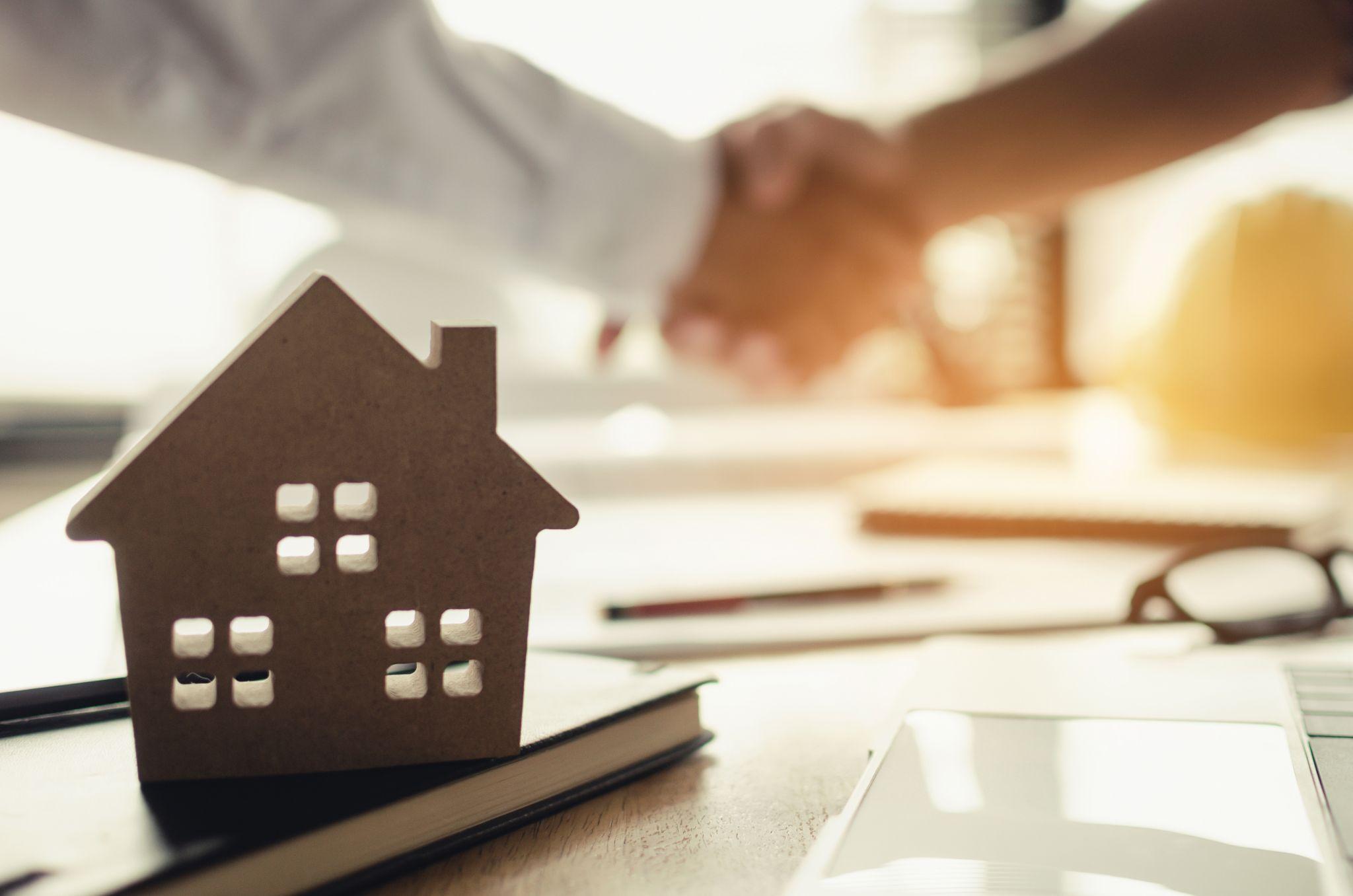 Paper representation of a home for sale
