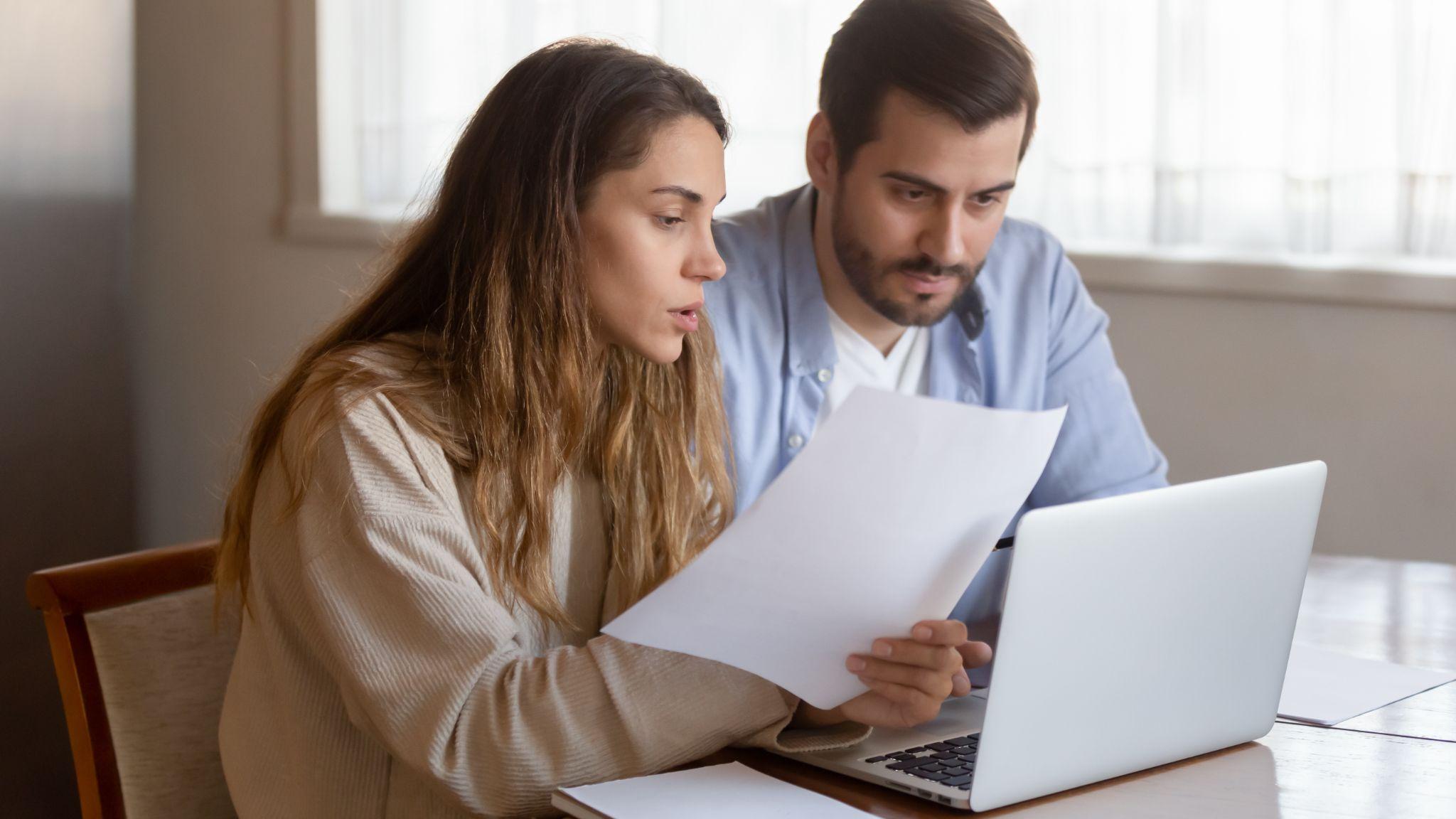 Homeowner couple looking at their mortgage paperwork