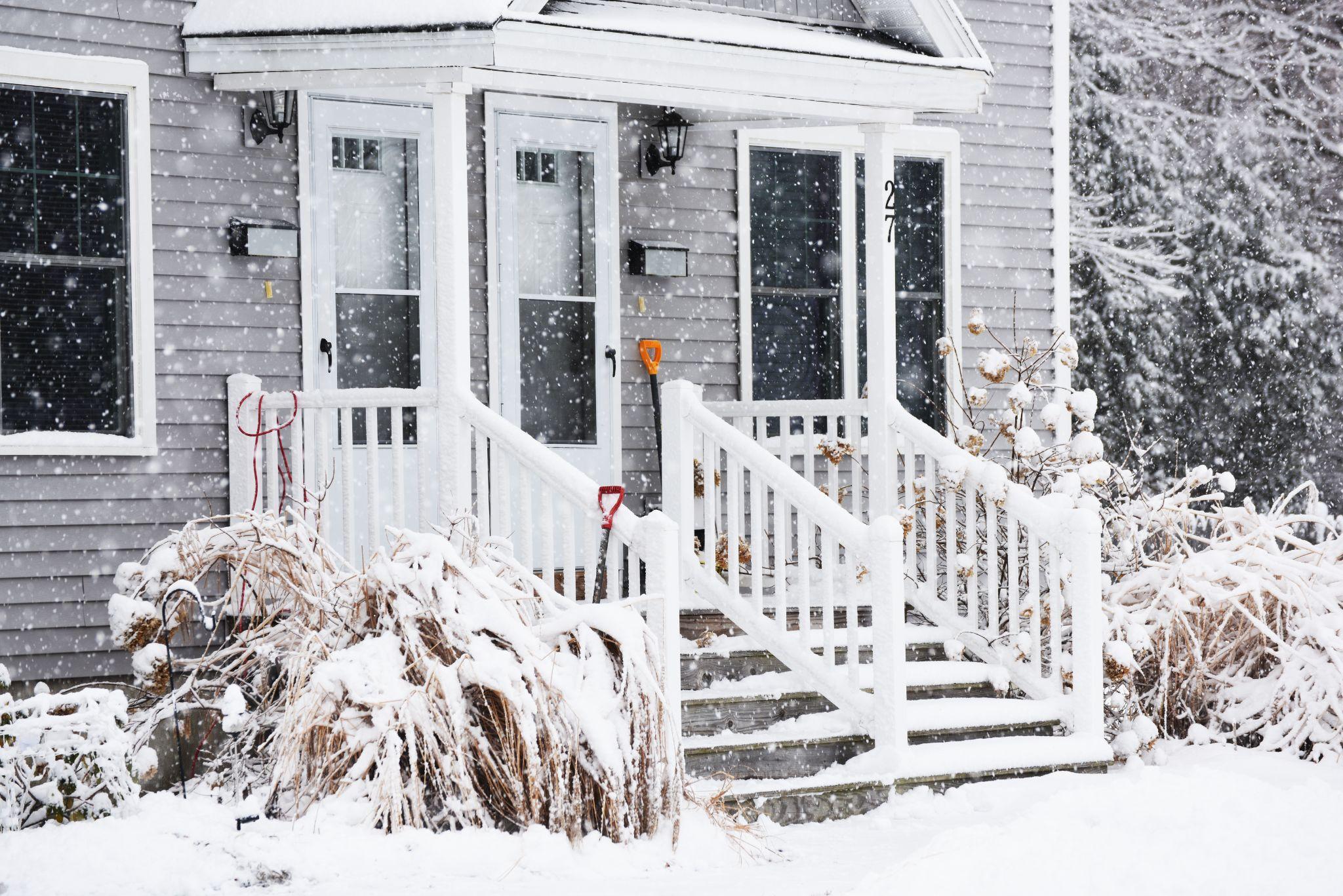 Front of a house with snow falling