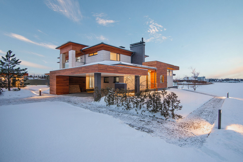 brick home is captured during a snow storm in this beautiful, Winter scene.