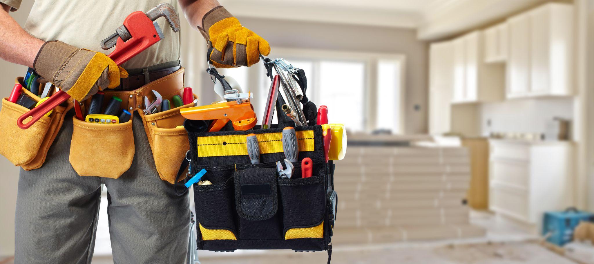 Builder handyman with construction tools.