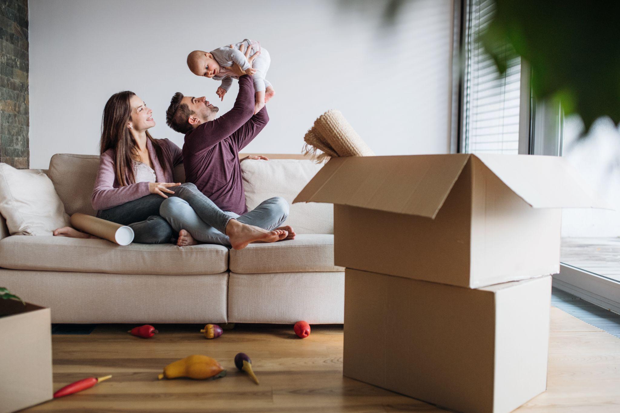 Couple with a baby who have recently moved into a new home
