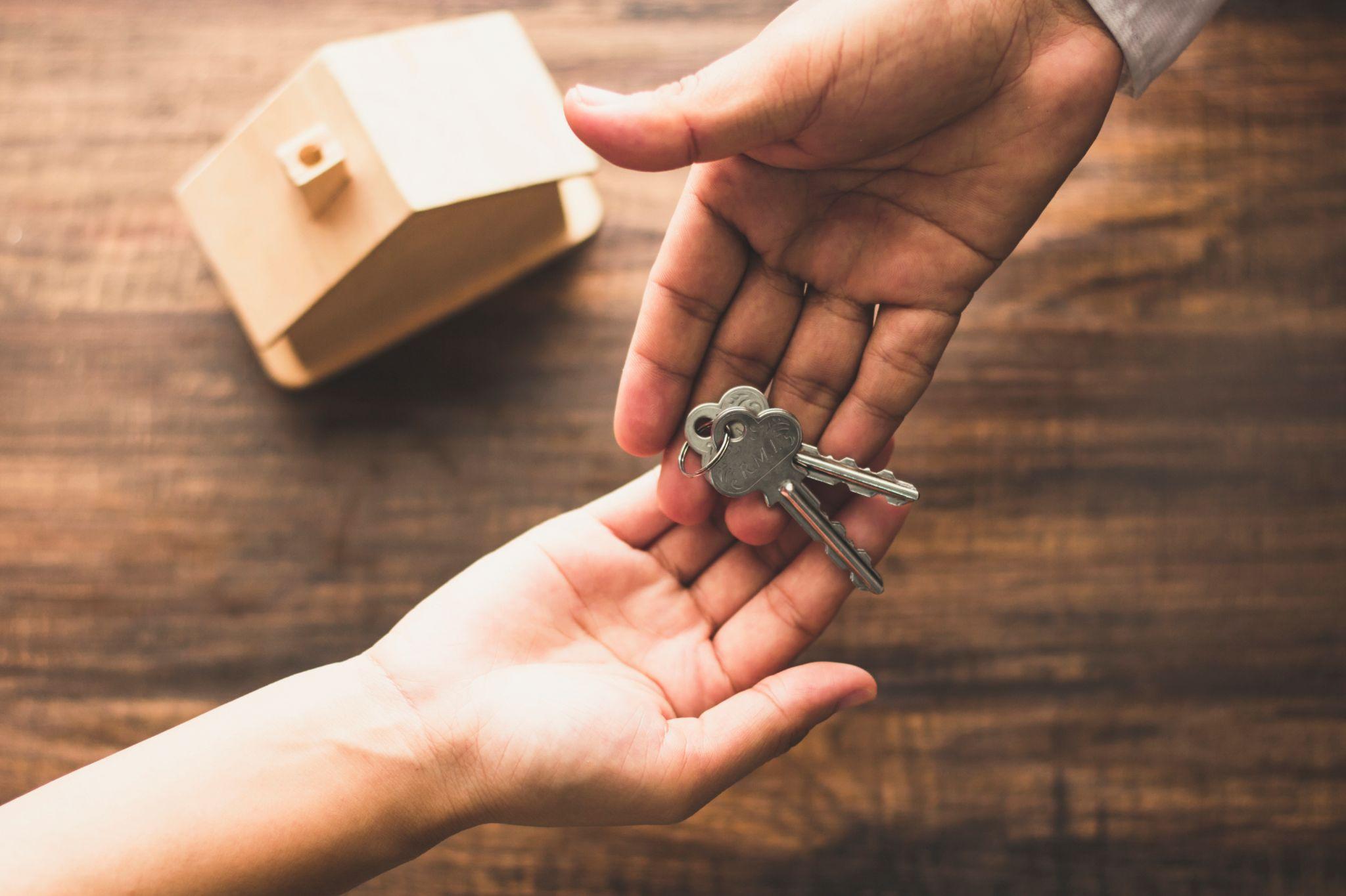 Homeowner handing over keys to a buyer