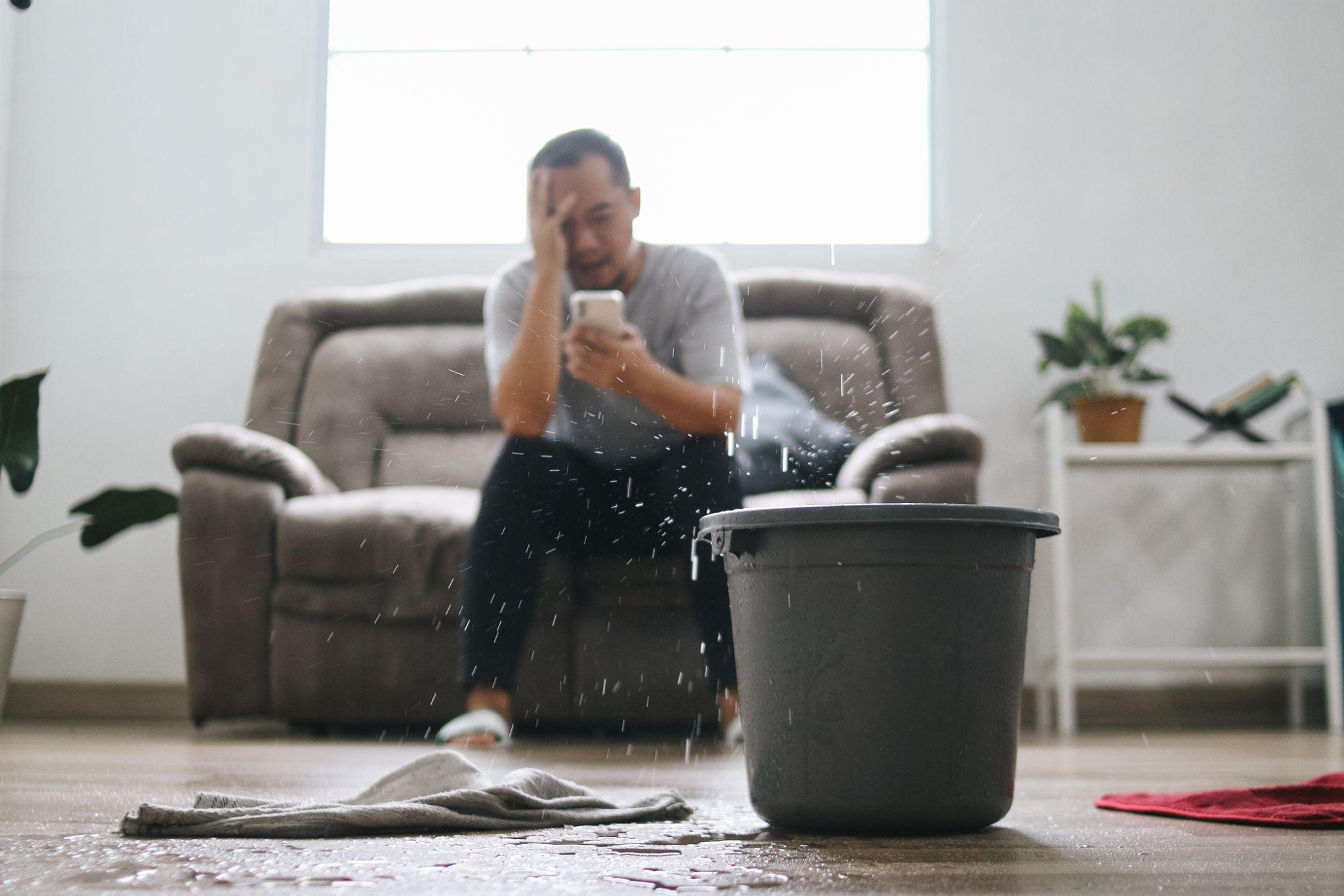 Man stressed because leaky roof in house for sale