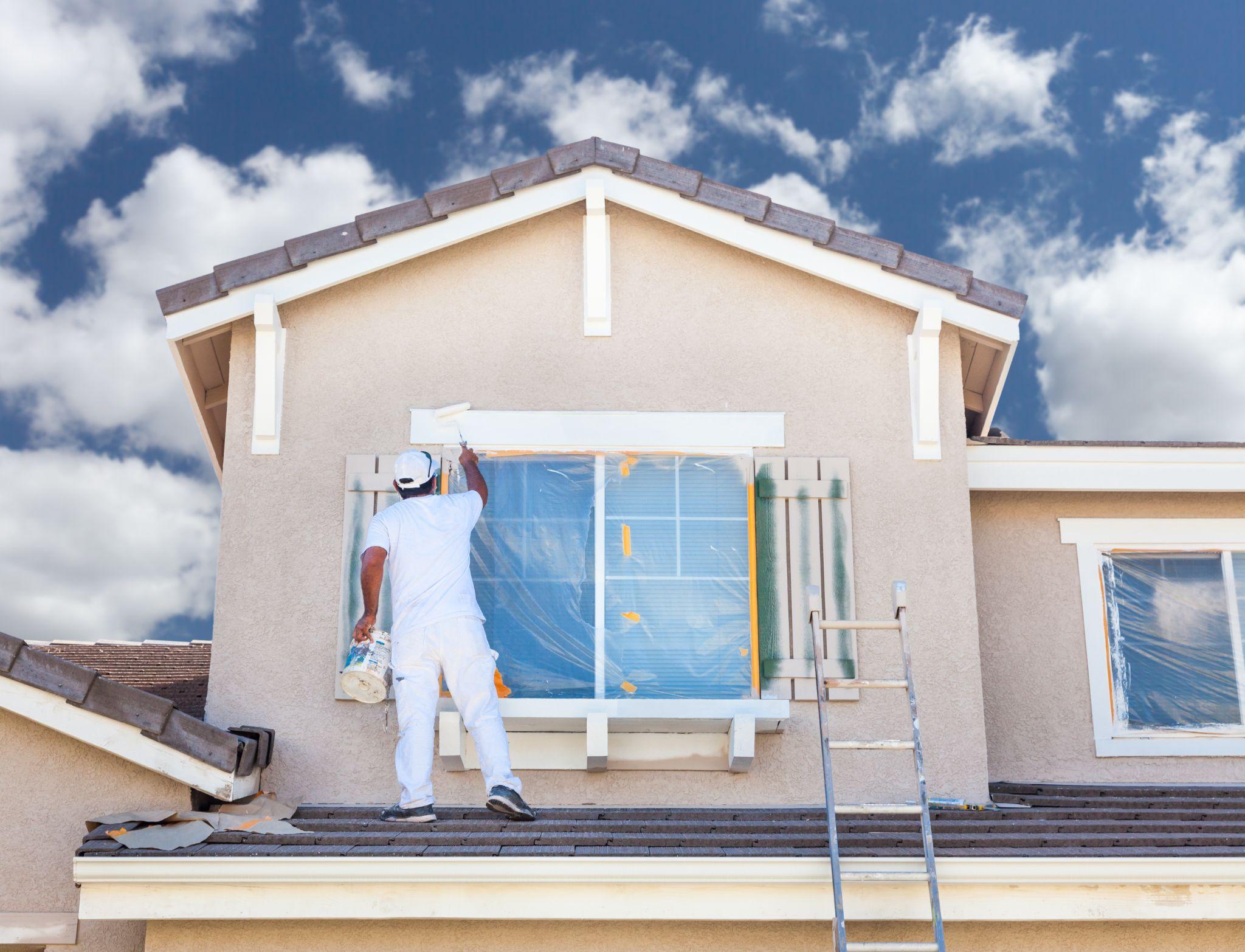 Painter painting a house to sell it