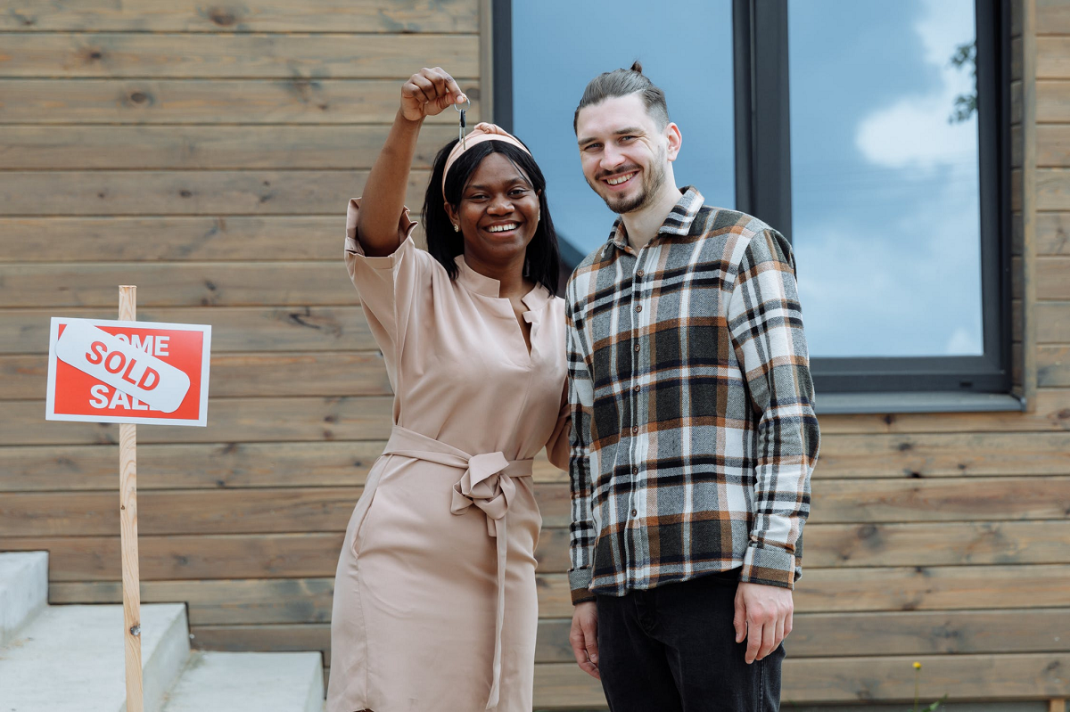 Smiling Woman Holding a Key